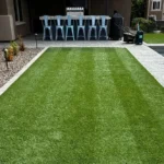 newly cleaned artificial turf in backyard with a pool
